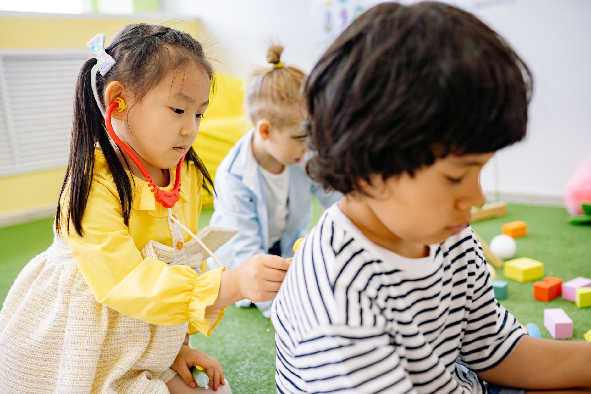 Toddlers playing in a British nursery, illustrating free childcare expansion UK problems 2026