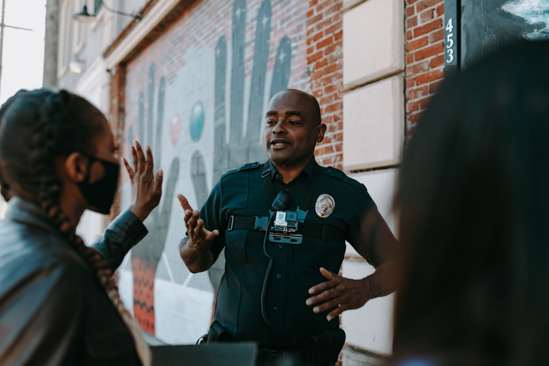 Police community officer talking to a young person on a British street in the context of knife crime UK towns 2026